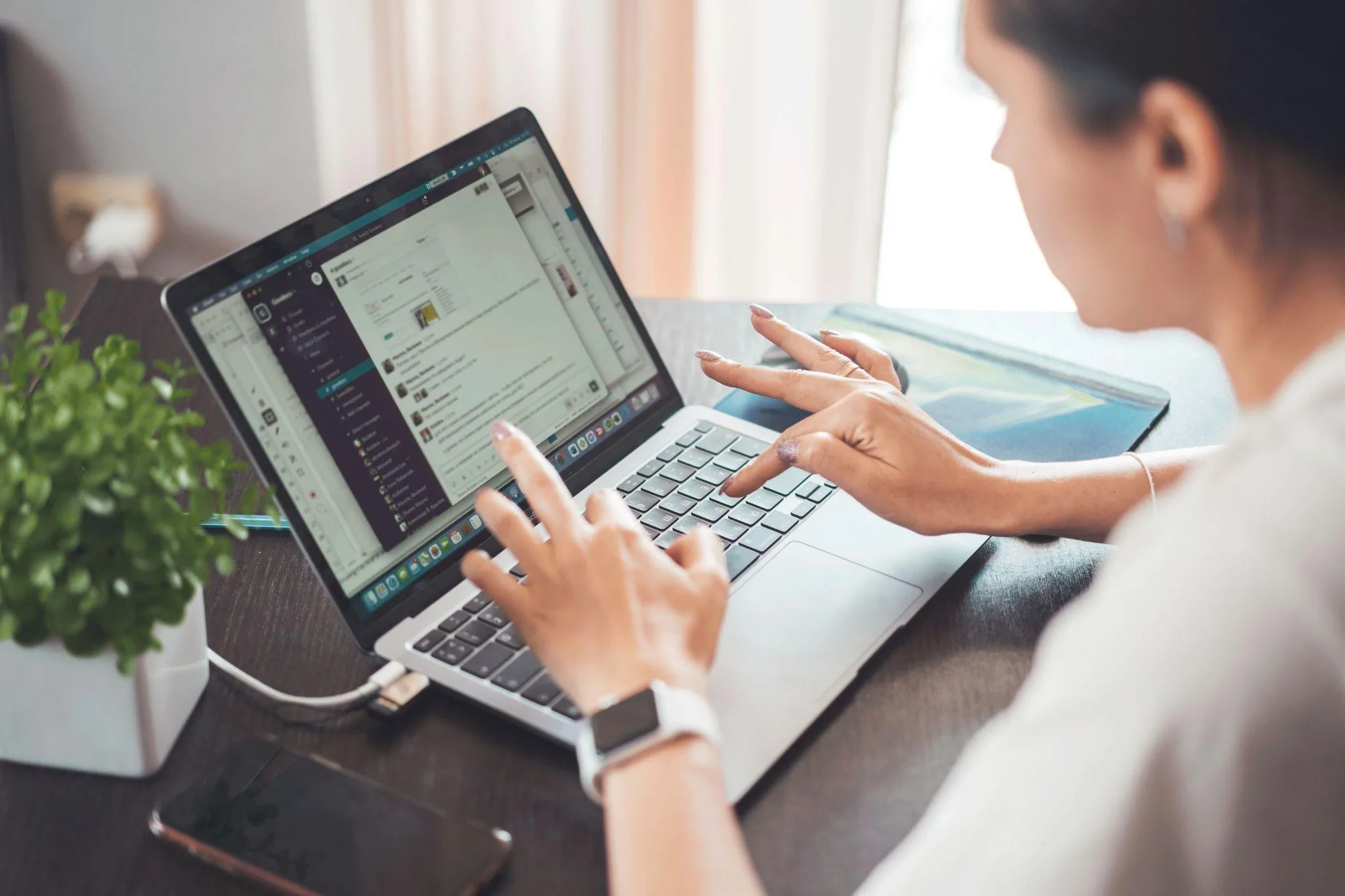 Property manager working on a laptop to run an Airbnb management business.