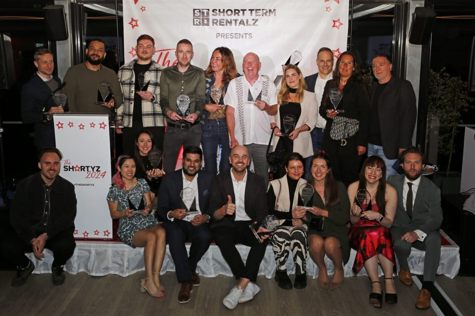 Hostify team members and partners at The Shortz 2024 awards ceremony group photo
