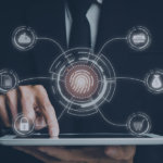 Tech-themed image with interconnected icons surrounding a central fingerprint, representing core PMS functions: secure access, document management, payment processing, user control, e-commerce integration, cloud storage, and identity verification. The layout conveys how a PMS centralizes critical operations through biometric authentication and digital connectivity.