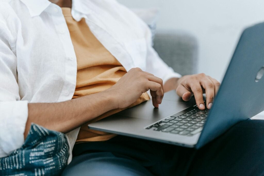 Property manager using laptop to manage vacation rental bookings and reservations
