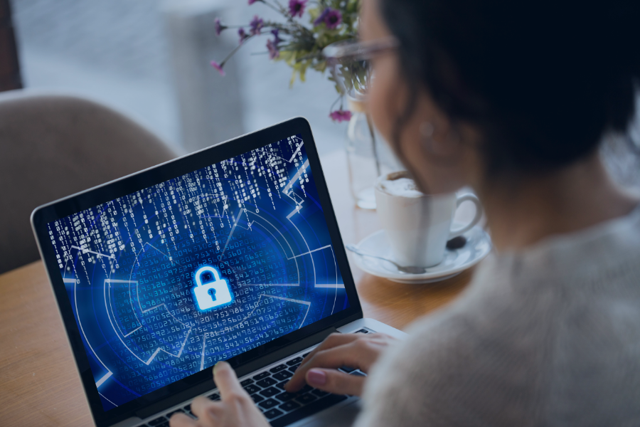 Property manager viewing encrypted data security interface on laptop at desk